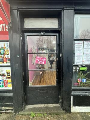 Black wood-framed glass door ahead. Push from handle on right to open.