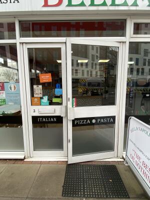 White metal-framed glass doors. Pull from handle in centre to open.