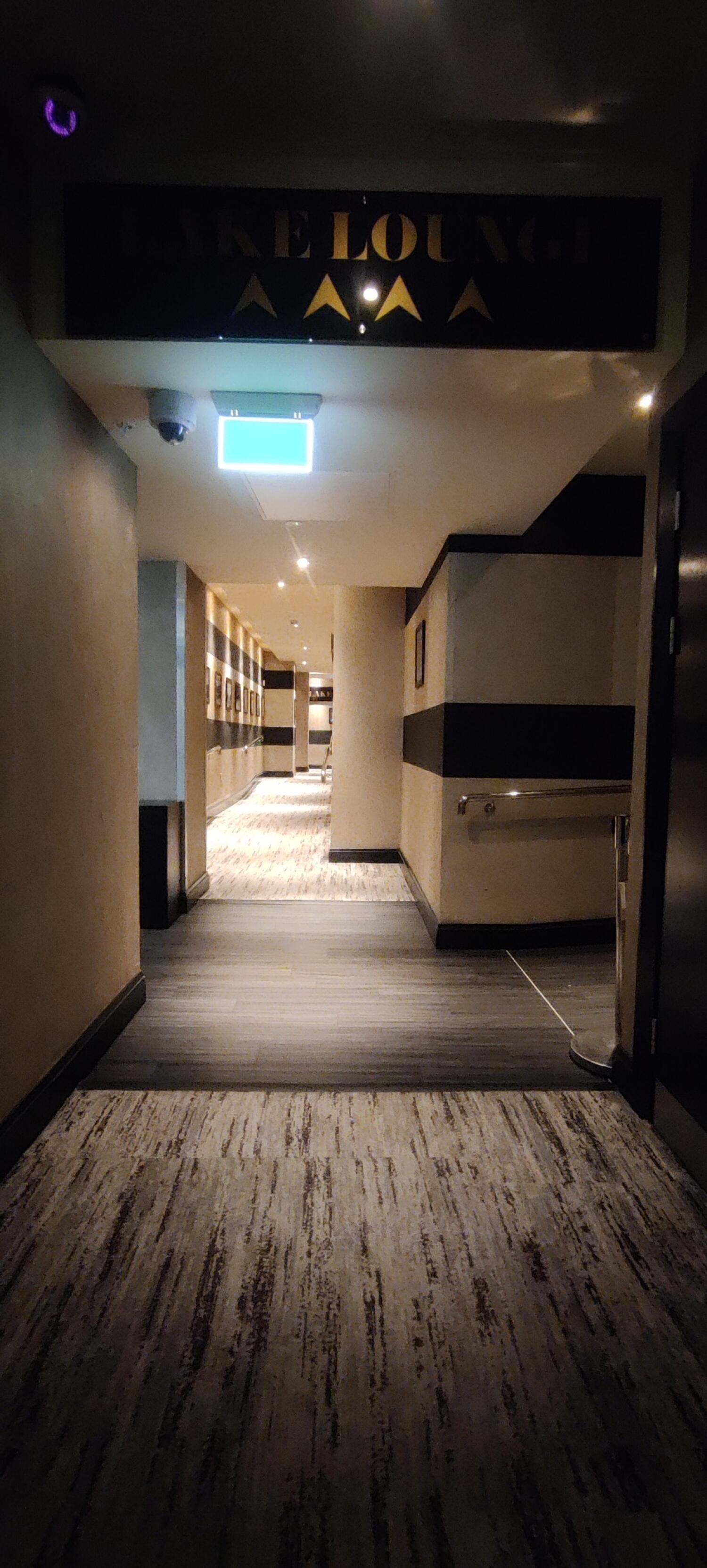 From second set of doors facing straight. Open archway ahead .