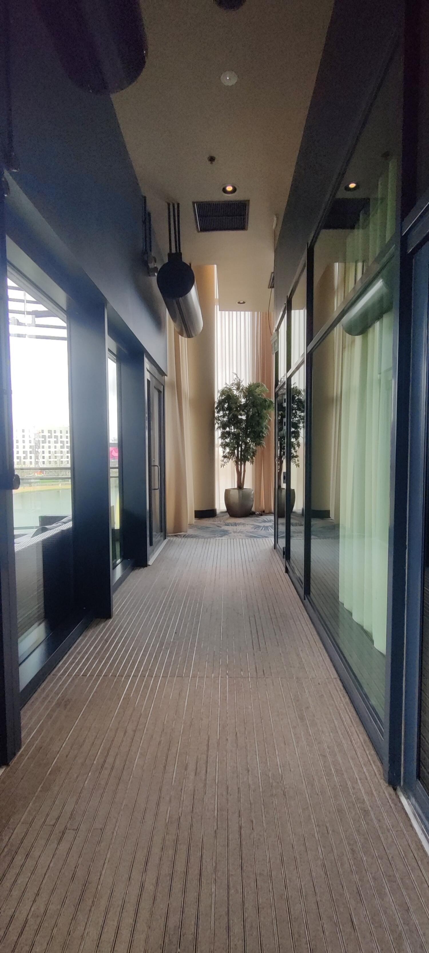 From door facing right. Path to seating area ahead. Planter at the end of the path.