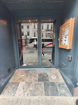 Facing entrance door. Pull handles in centre to open.