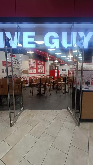 Glass doors with metal handles at centre. Pull to open.