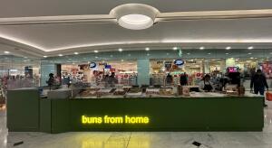 From mall corridor facing straight. Kiosk ahead. Till counter on right.