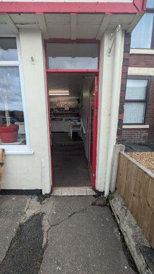 Red metal-framed glass door. Push from handle on right to open.