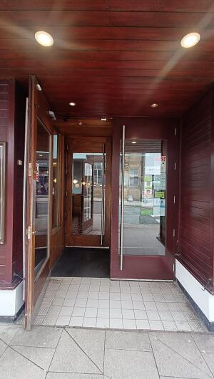Red wood-framed glass doors. Pull from vertical handles at centre to open.