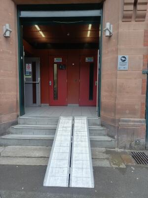 Green double doors ahead. Push from centre to open. Three steps up before door.