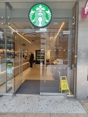 Glass doors with metal handles at centre. Push from handles to open.