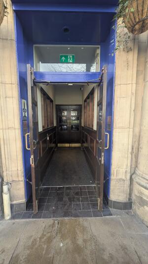 Dark wooden doors with glass panels. Pull from handles in center to open.