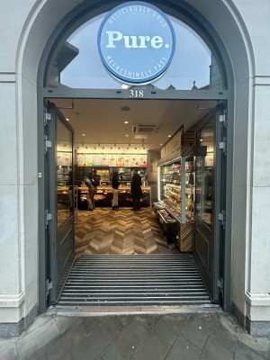 Grey wooden doors with large glass panels and silver metal handles in middle. Push to open.