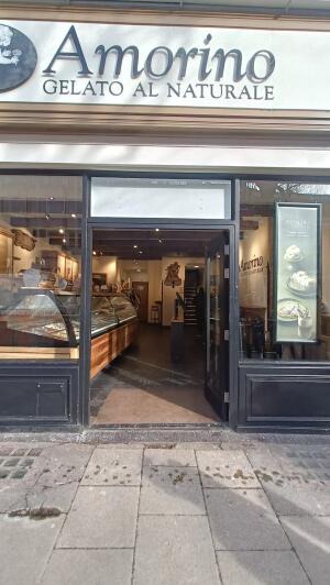 Black-framed glass door to venue. Push from handles on left to open.