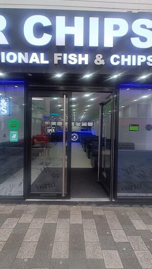 Glass doors with black metal frame to venue. Push from metal handles at centre to open.