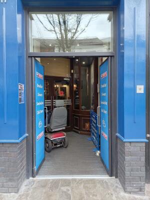 Blue double doors ahead. Push from handles at centre to open.