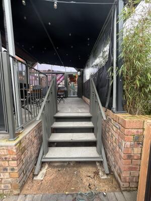 Staircase ahead, leading up. Handrails along left and right.