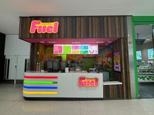 From mall corridor facing venue. Counter at back. Till to right. Menu boards above counter.
