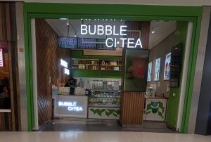 From mall facing venue. Counter along back with till on left.