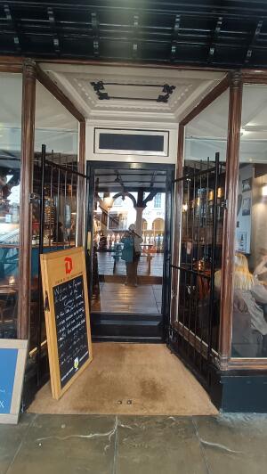 Black metal door to venue. Push from handle in centre to open.