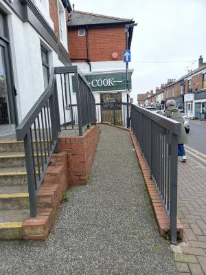 From street facing venue. In-built ramp in centre ahead. Guard rails on left and right.
