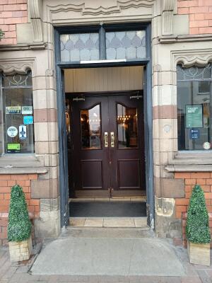 Grey wooden doors ahead. Push from handles at centre to open.