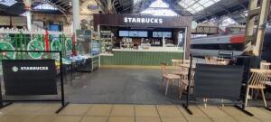 Open entrance to the venue in the centre. Fences across left and right.