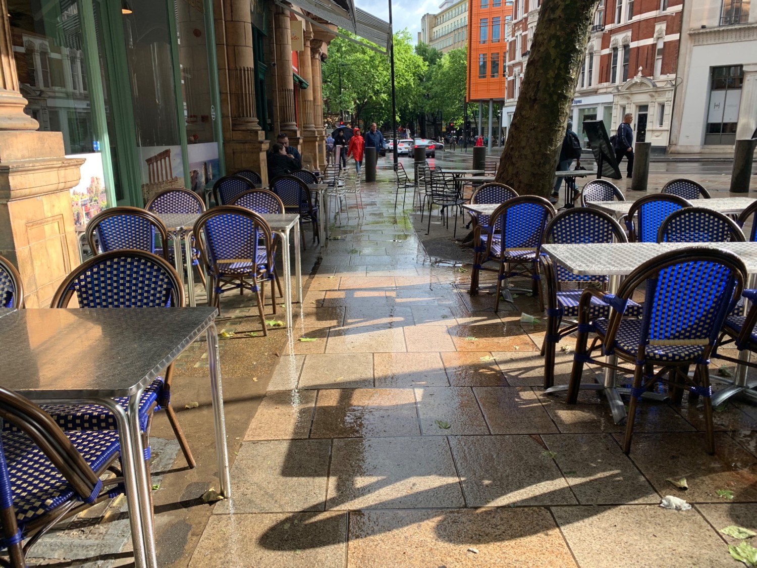 From path from entrance, looking left. Tables and chairs along right and left of path.