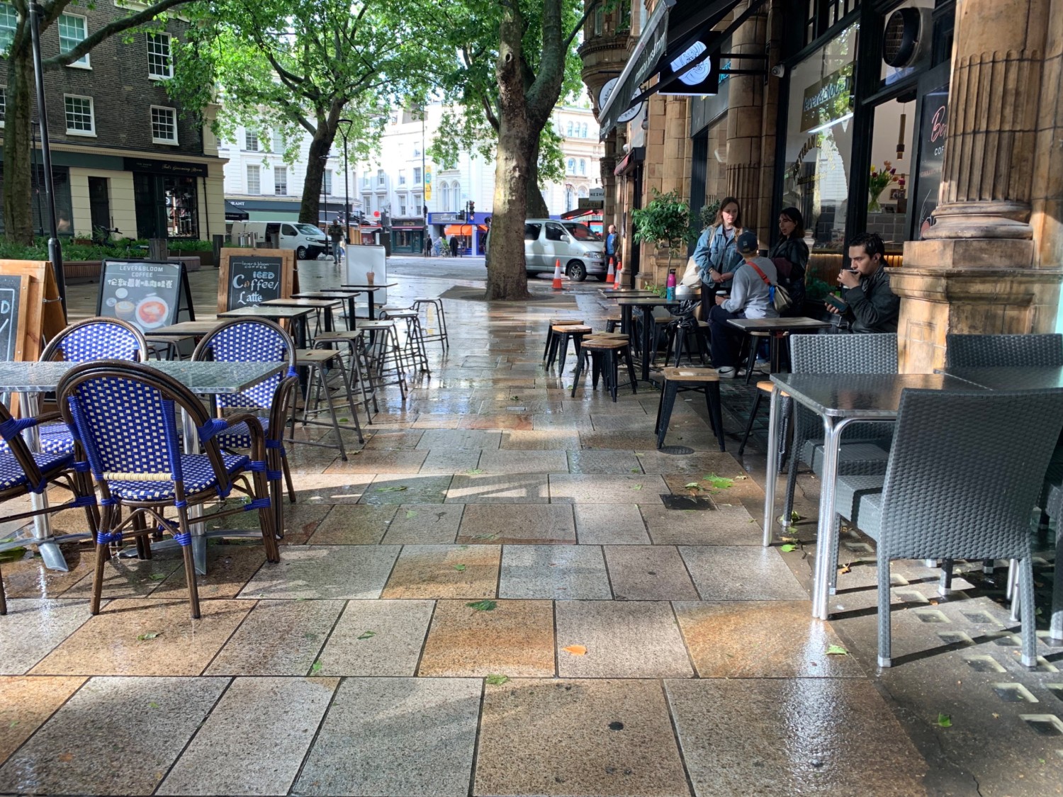 From path from entrance, looking right. Tables and chairs on right and left of path.