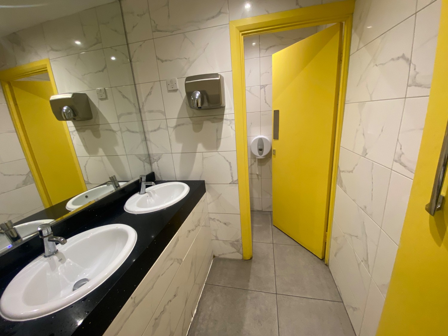 From door, facing straight. Two sinks along left. Path ahead in front.