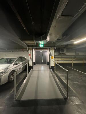 From carpark facing entrance path to Basement. Ramp up to doors. Handrails on left and right of ramp.