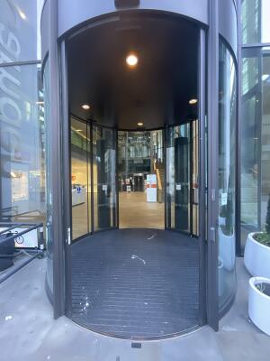 Black-framed curved glass sliding doors. Doors slide sideways to open.