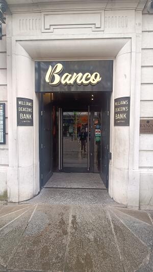 Black wooden door to venue. Push from handles at centre to open.