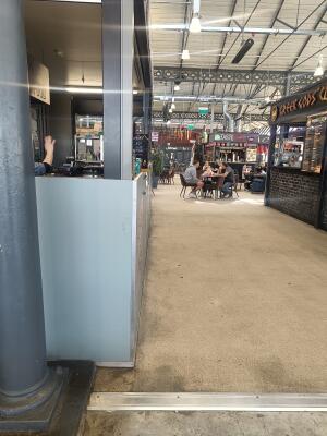 Small bump at foot of entrance. Tables and chairs ahead.