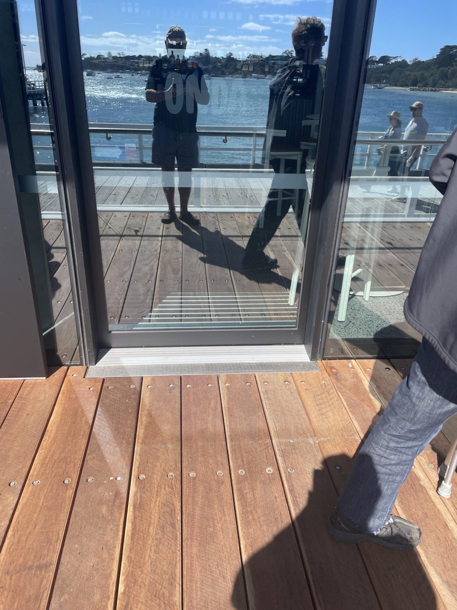 Dark metal-framed glass door. Small bump at foot of door.