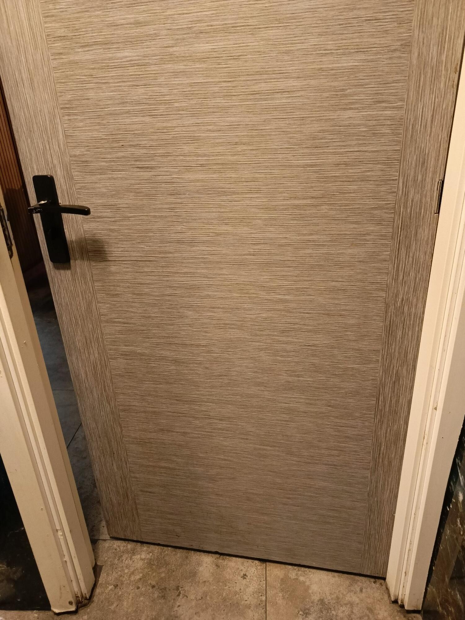 From back of door. Push from handle on left to open.
