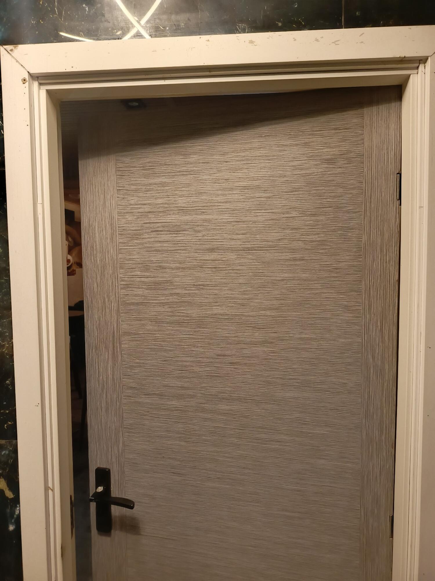 From back of door. Push from handle on left to open.