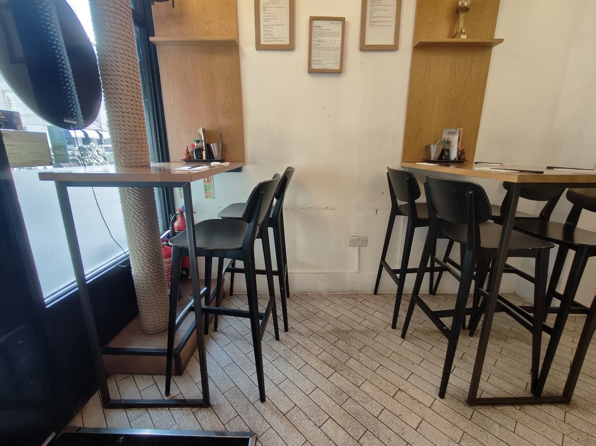 From entrance facing left. High table and stools along left and back right.
