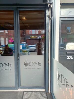 Grey metal-framed glass door ahead. Twist push handle on left to open.