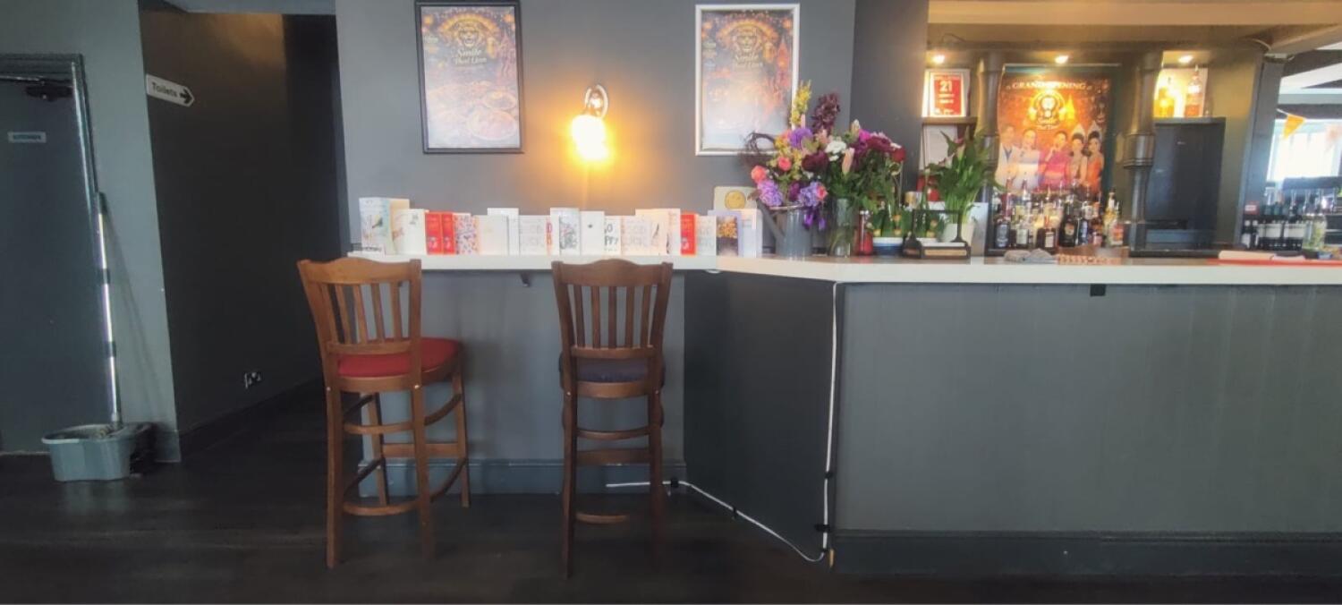 From entrance facing right. High table and stools on left. Counter along right.