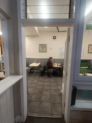 White framed glass panelled door to venue. Push handle on left to open.