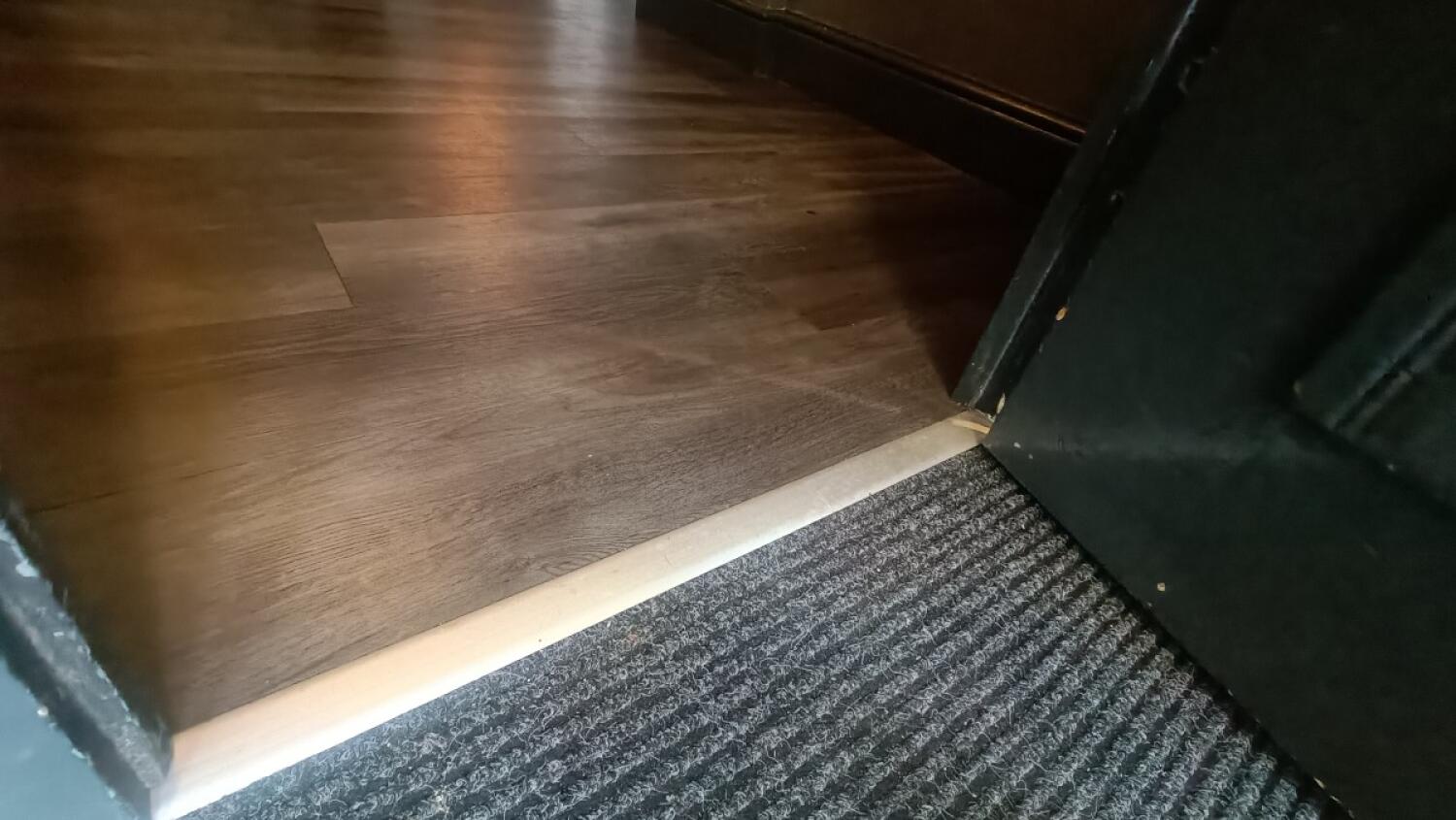 Doormat leads to small bump at foot of door.