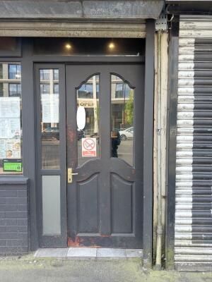 Dark grey wooden door with glass panels. Use handle to open.