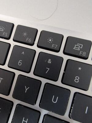 A close-up view of a laptop keyboard showing function keys F5 through F8, alongside the 6, 7, 8, Y, and U keys.