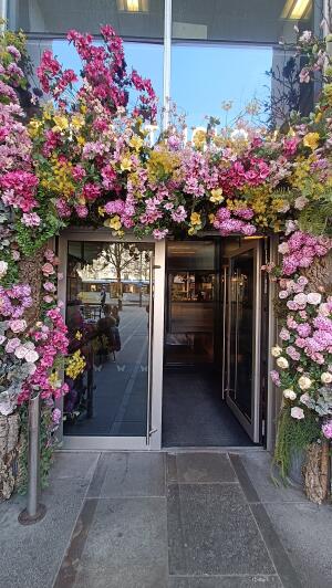 Metal-framed glass doors to venue. Push handle to open.
