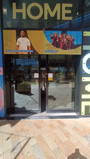 Dark metal-framed glass automatic doors ahead.