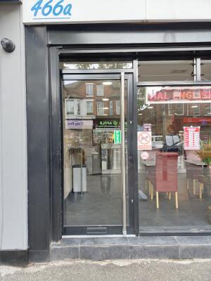 Black framed glass door ahead. Use handle to open.
