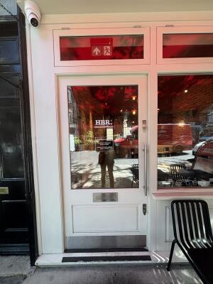 White wooden glass door ahead. Push handle on right to open.