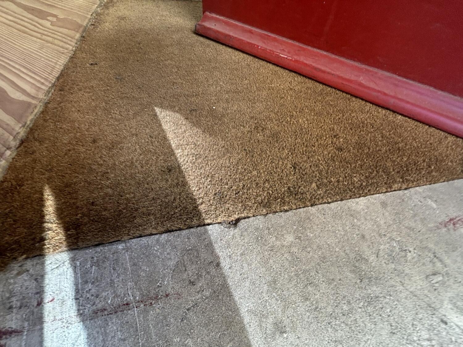 Doormat following foot of door.