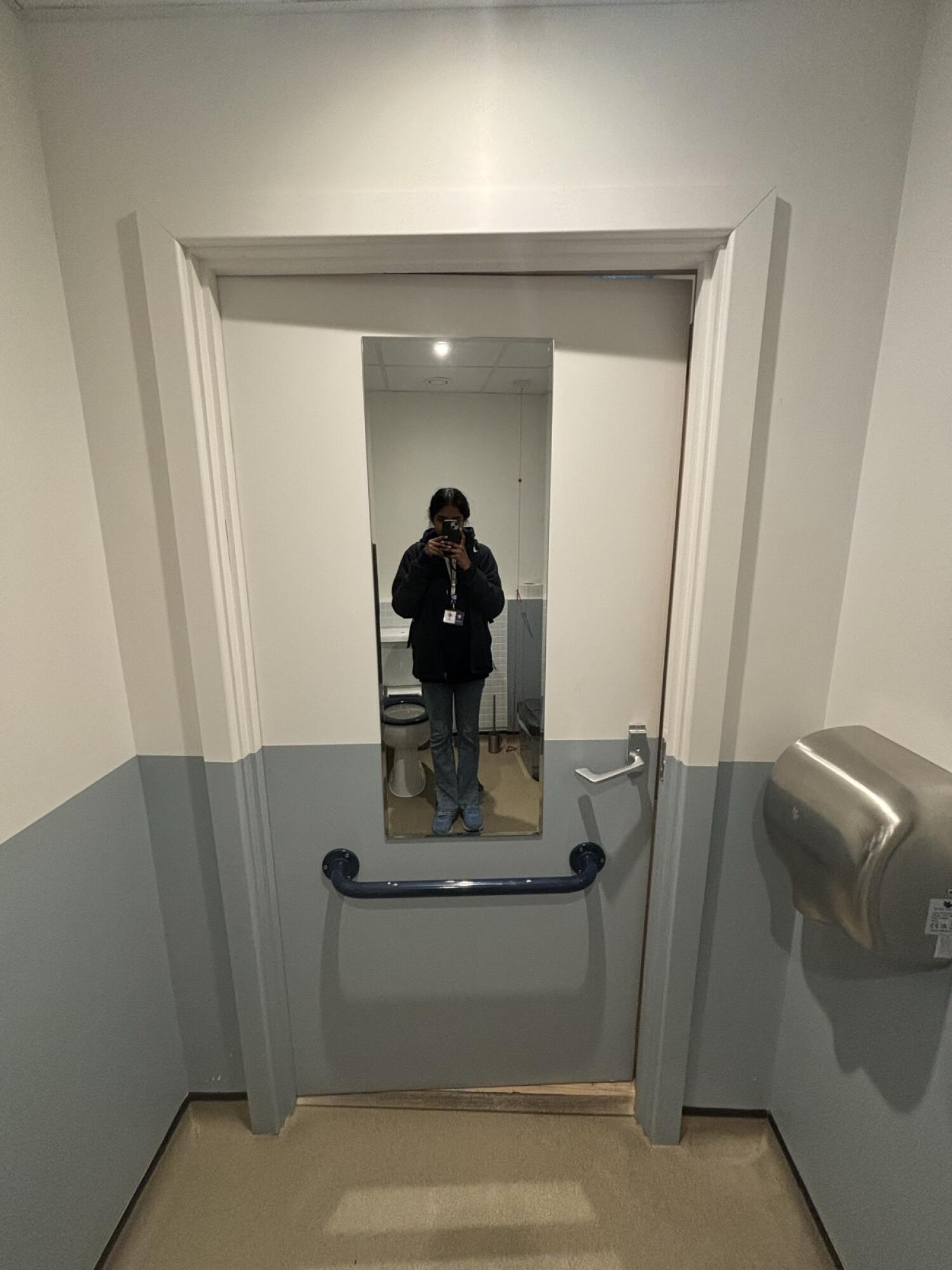 Back of door. Grab rail across centre. Lock and handle on right.