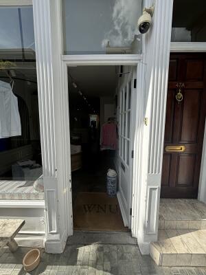 White wooden glass panelled door ahead. Push from left to open.