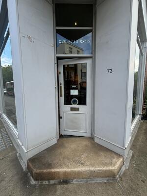 White wood-framed glass door ahead. Push from left to open.