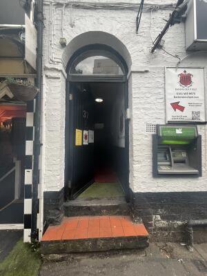 Black door with two steps to doorway.