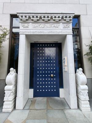 Blue metal studded door. Use handle to open.